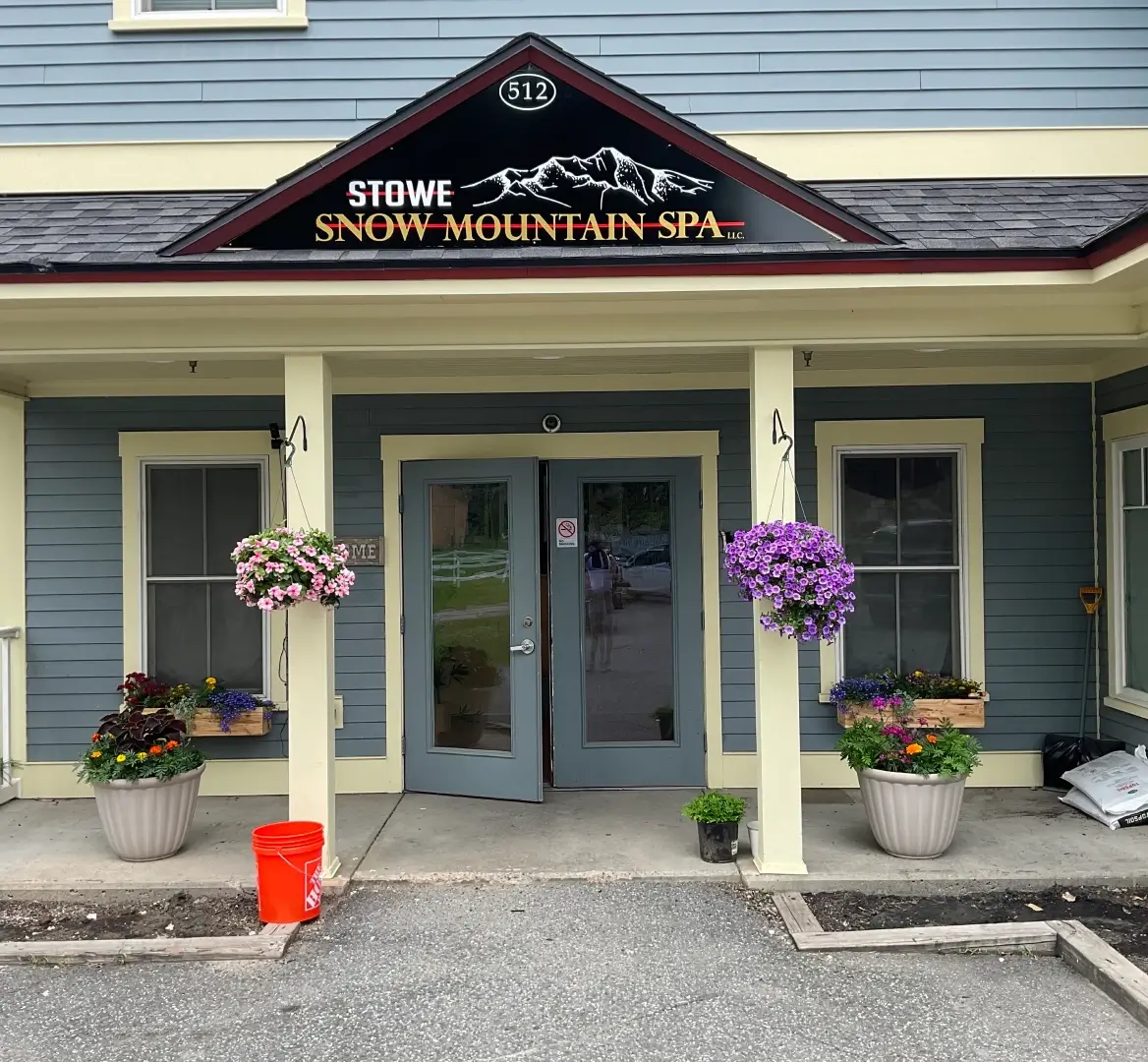 Spa entrance with hanging flower baskets.