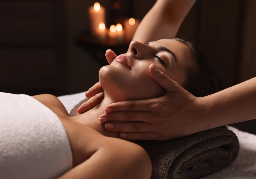 Woman receiving a relaxing facial massage.